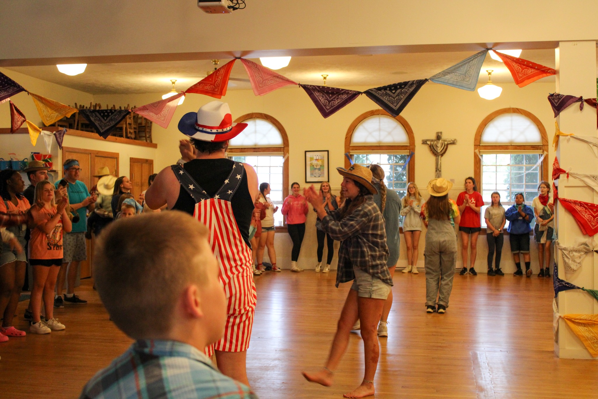 A photo of people clapping their hands during a square dance.